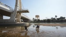 Iraqi fishermen walk in the Tigris river as it witnesses a sharp decrease in water levels in Amara, Iraq March 1, 2023. REUTERS/Essam Al-Sudani