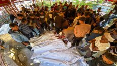 EDITORS NOTE: Graphic content / Palestinians mourn by the bodies of relatives who were killed by Israeli fire as they gathered near a US-backed aid center, at the Nasser hospital in the southern Gaza Strip on June 3, 2025. Rescuers said the Israeli military killed at least 15 people on June 3 in southern Gaza near a US-backed aid centre, with the army reporting it had fired on "suspects who advanced toward the troops". (Photo by AFP)