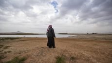 A Syrian man walks amidst drought and low water levels in the Euphrates River, in the western countryside of Tabqa in Syria's Raqqa governorate, on November 22, 2022. (Photo by Delil SOULEIMAN / AFP)